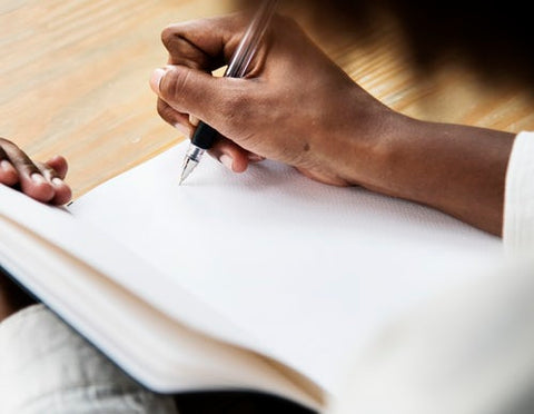 Woman writing her memoir by hand