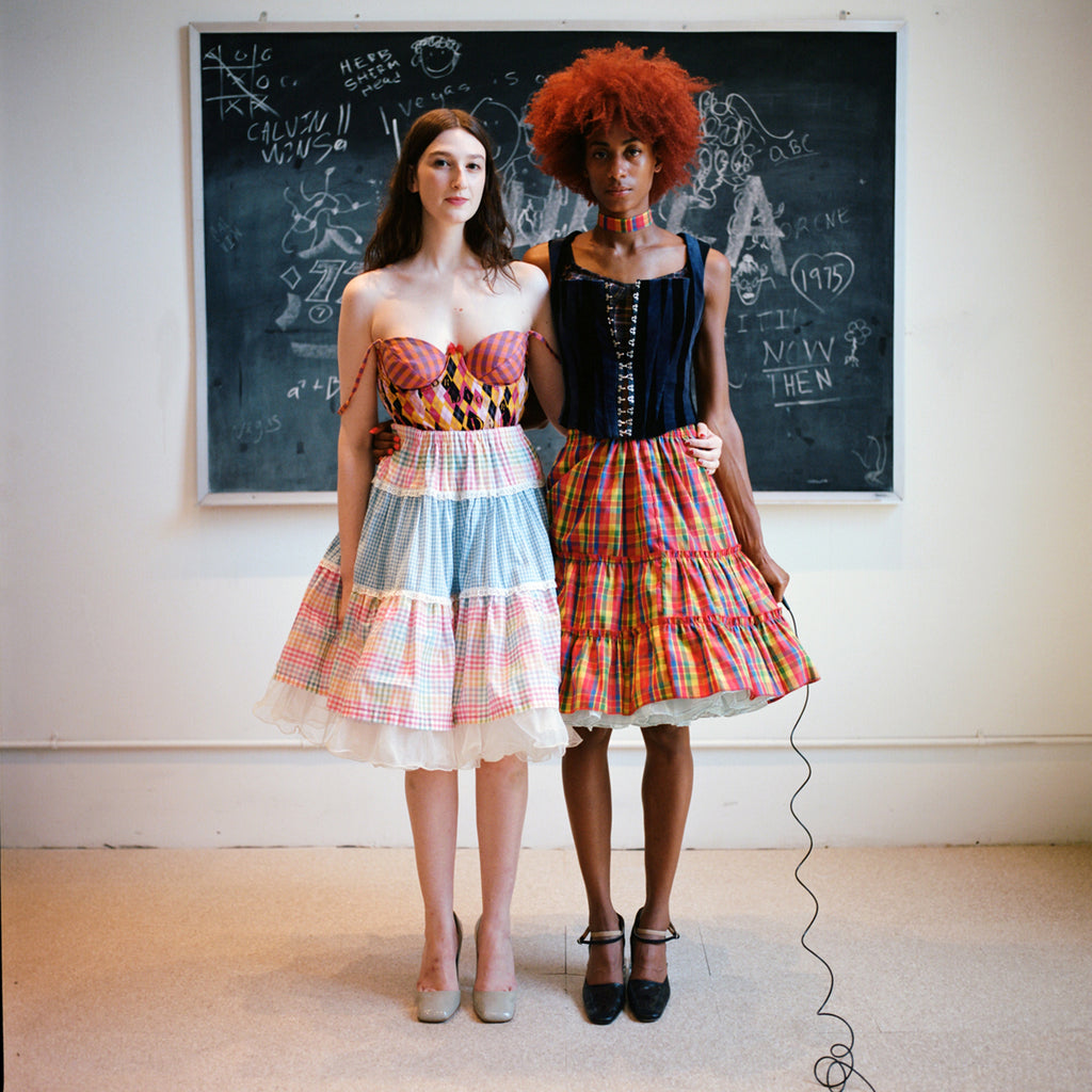 two models in front of a chalk board. 