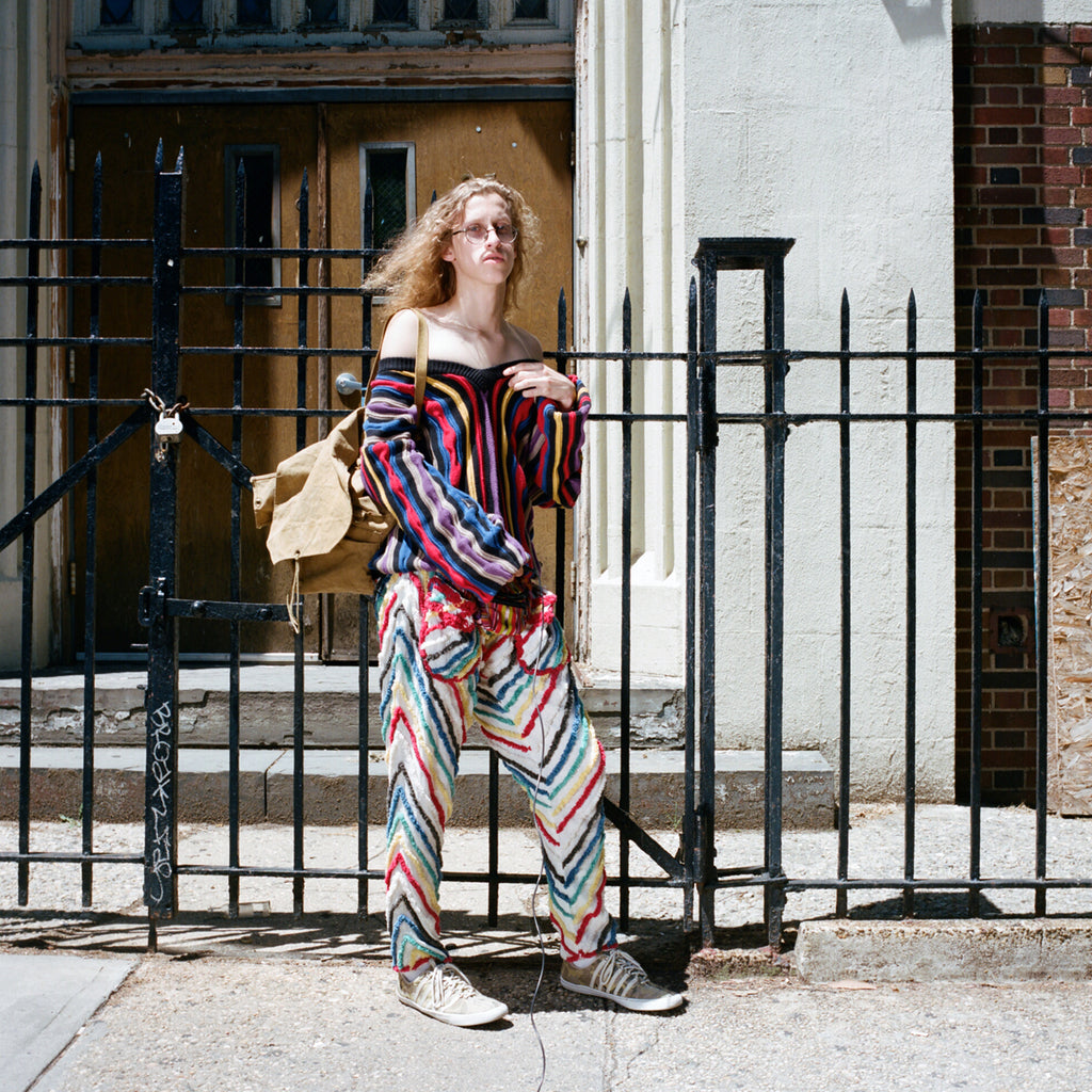 model in front of gate. 