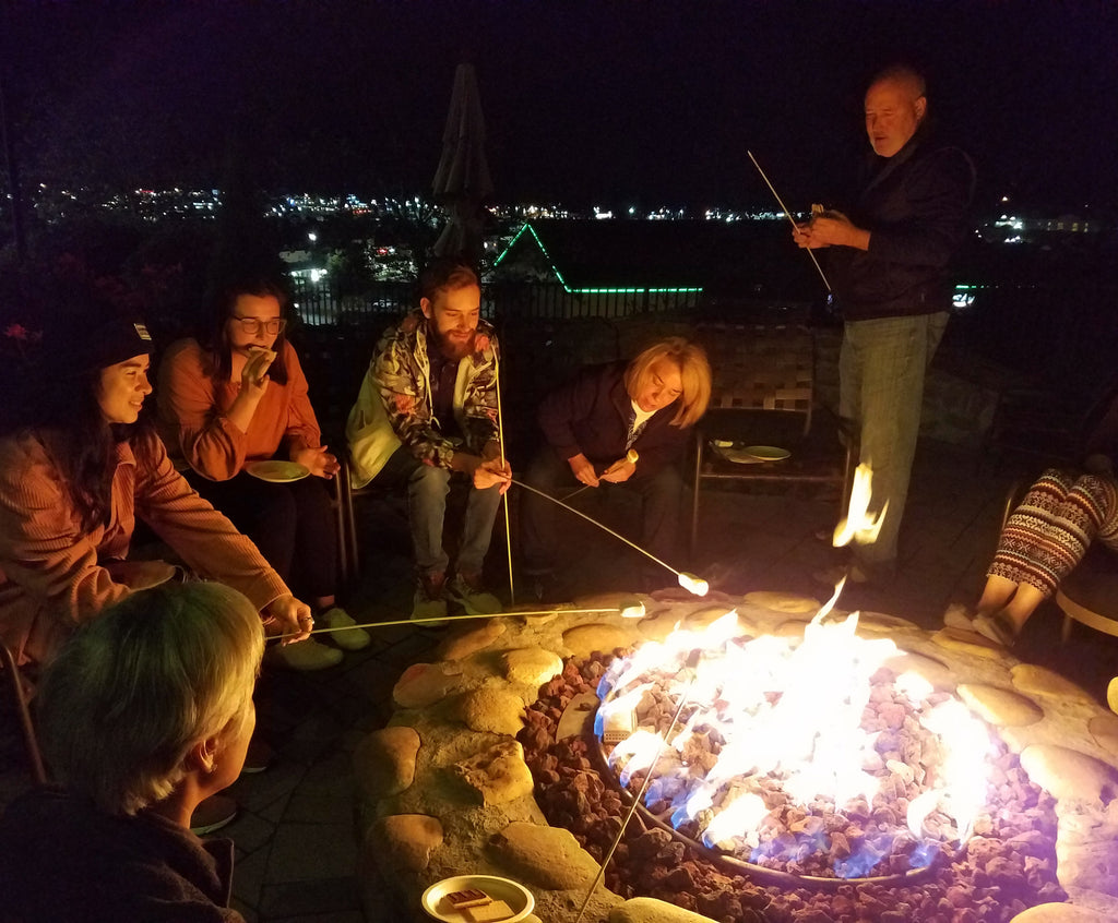 group of people toasting marshmallows.