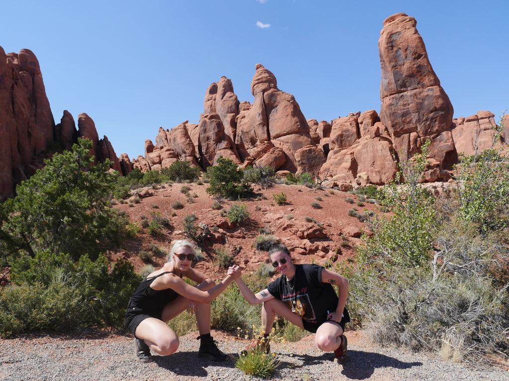 two people holding hands, posing for a picture.