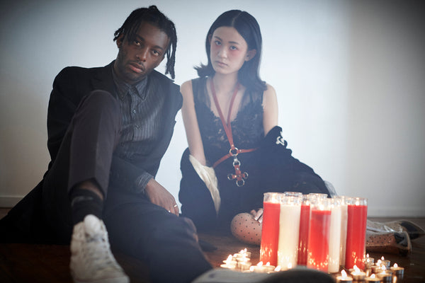 models seated around lit candles.