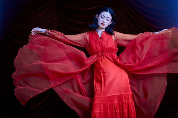 model posing with dress floating.