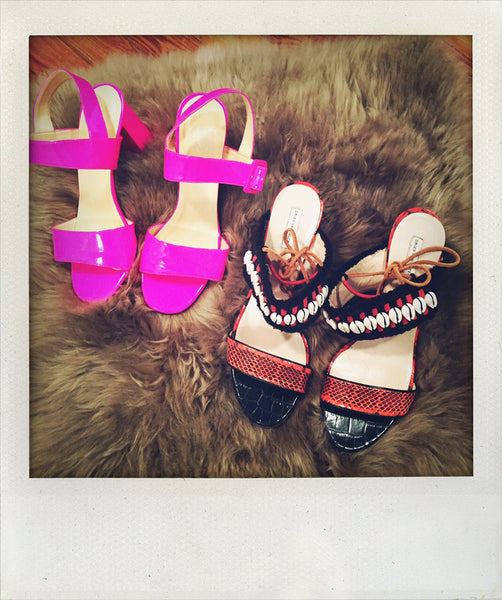 two pairs of sandals on faux fur.