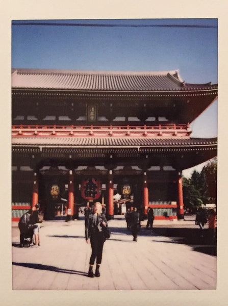 polaroid of person standing at senso-ji shrine.
