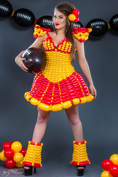 designer in another football inspired ballon dress holding a balloon football again.