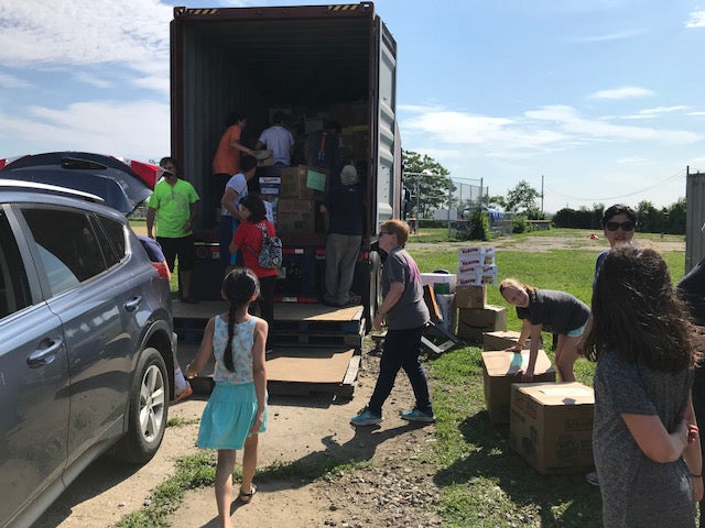 volunteers helping load onto truck.