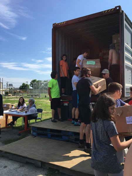 volunteers loading packed boxes onto truck.