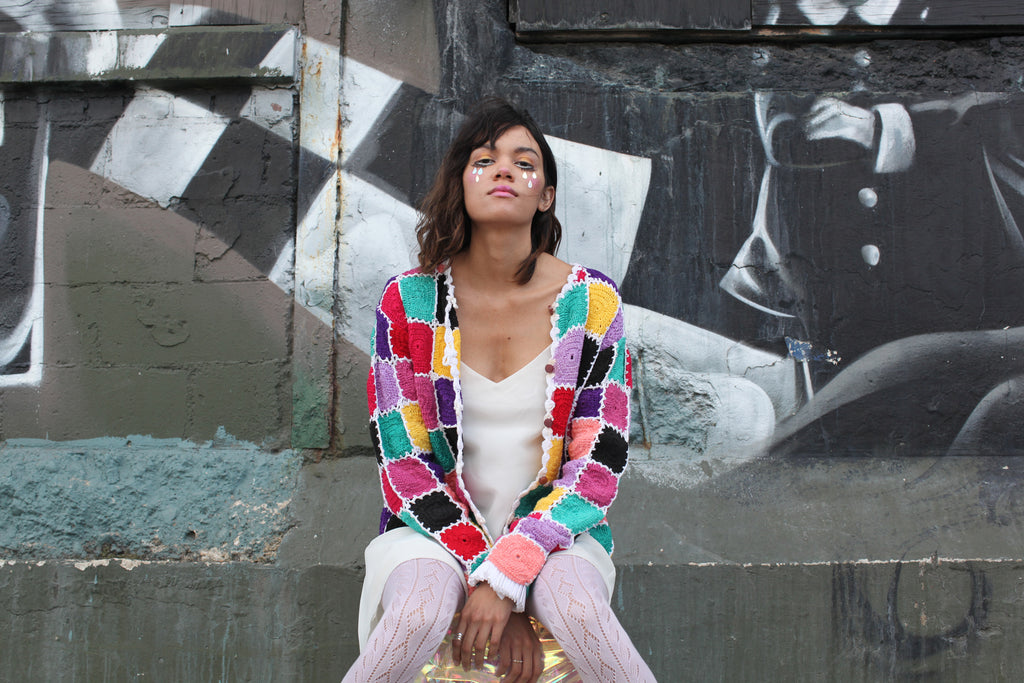 reed in patchwork sweater and clown makeup featuring tear drops