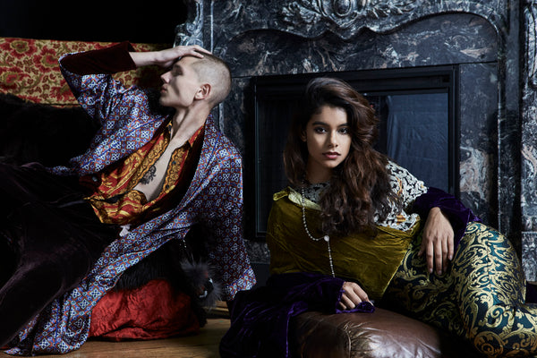 models posing in mixed prints lounging in front of a fire place