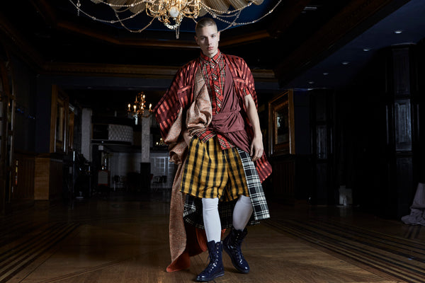 full look of layered tartan model with white tights and boots.