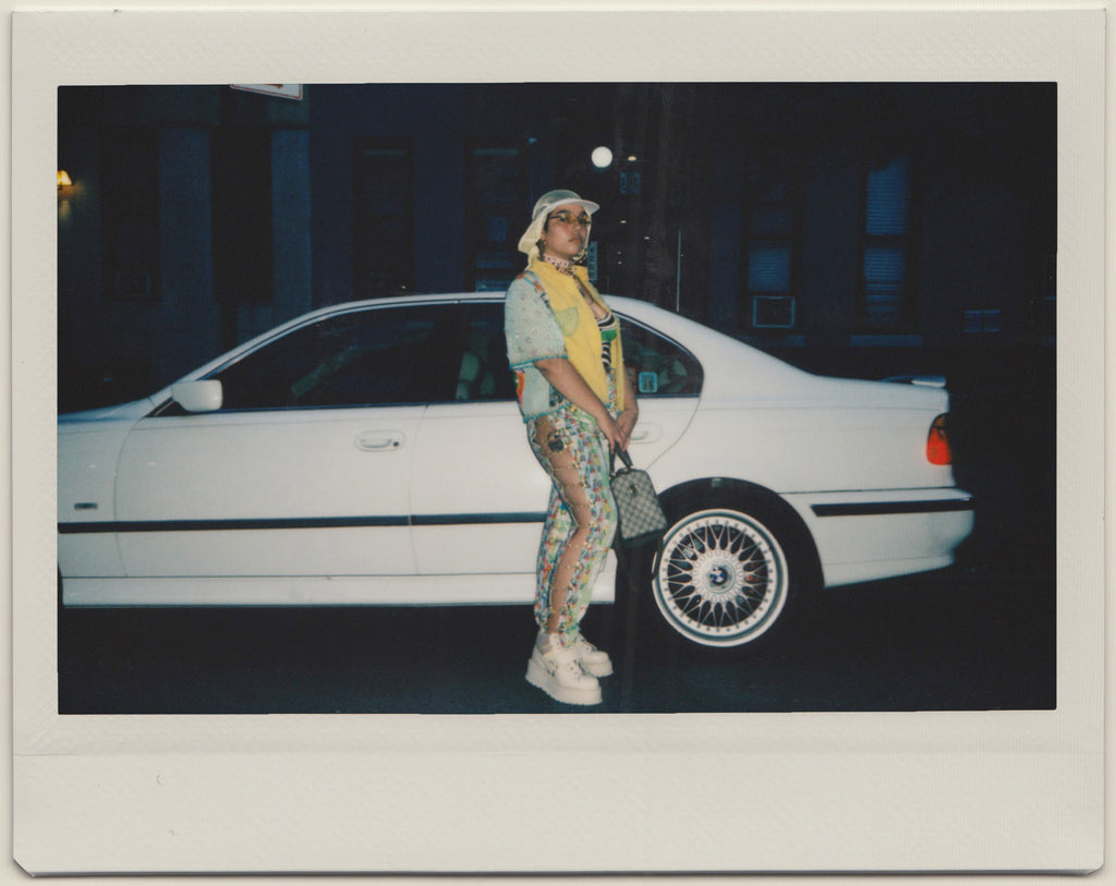 gabriela posing in front of bmw.