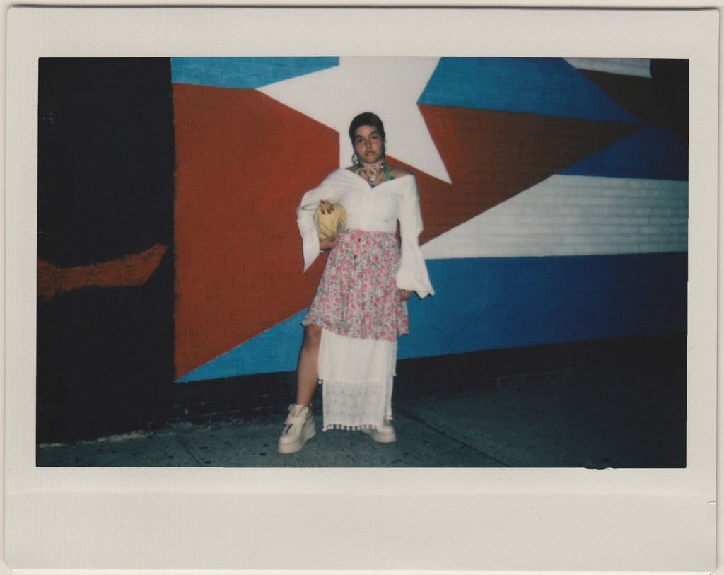 gabriela standing in front of puerto rican flag.