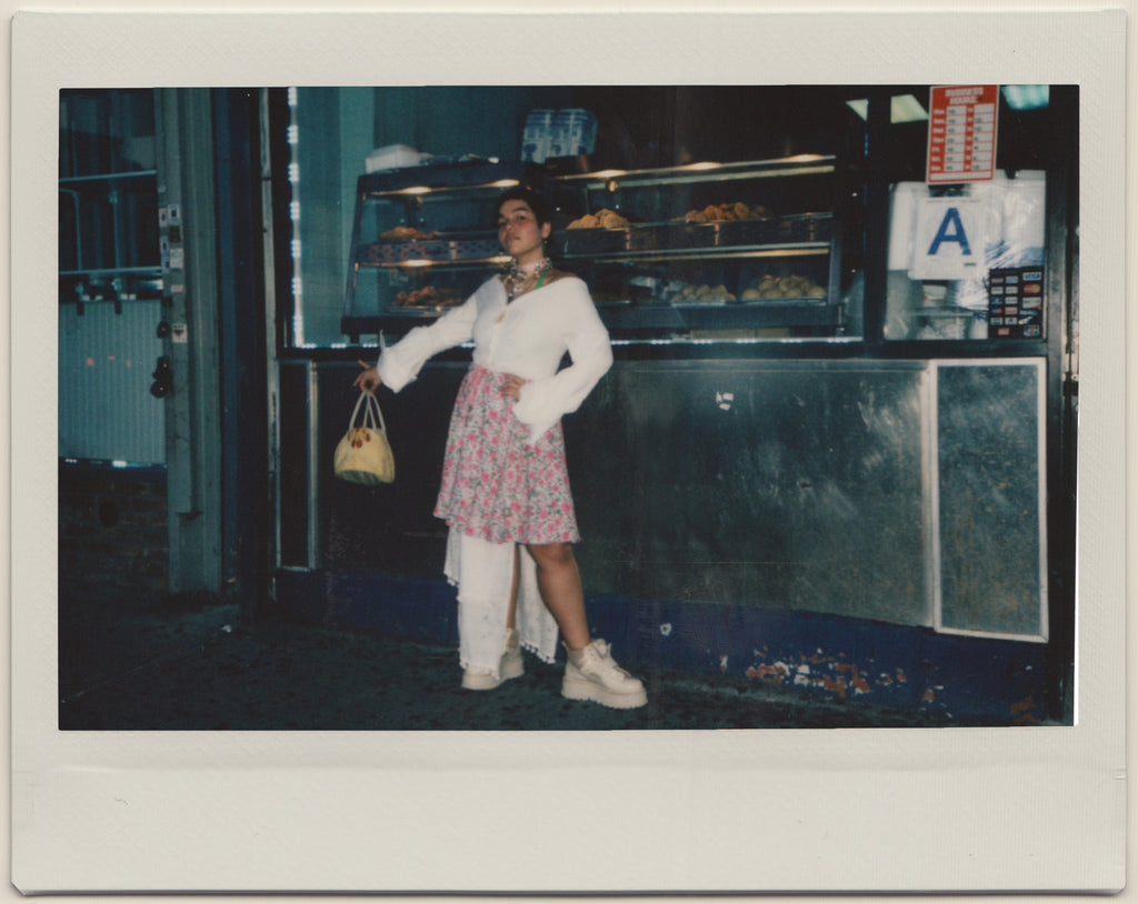 gabriela posing in front of bakery.