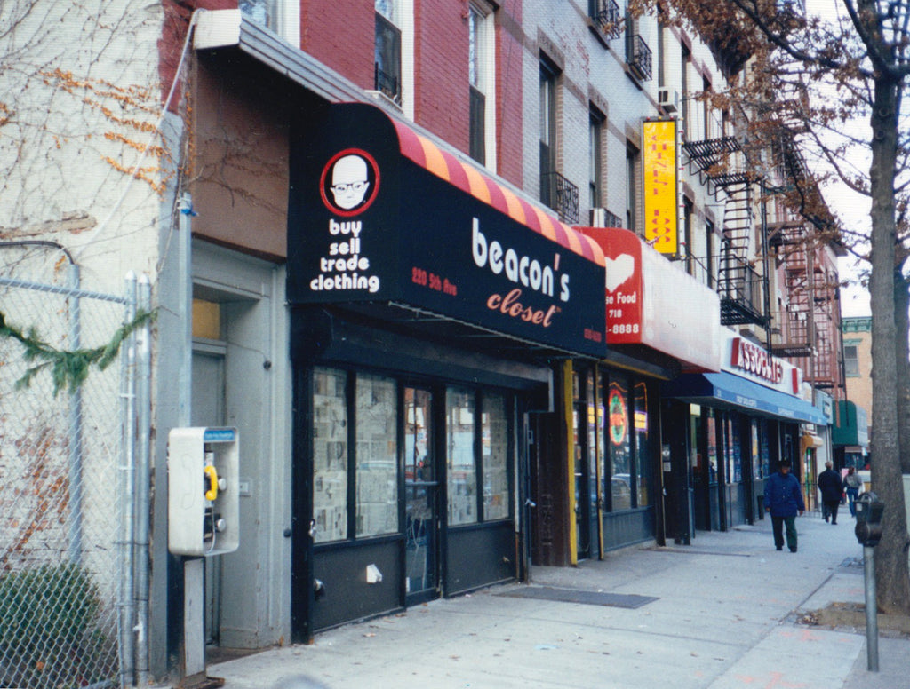 the first park slope location, black awning with babyhead wearing eyeglasses logo