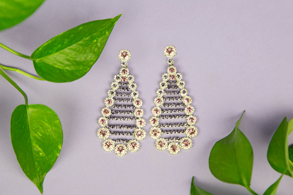 still life of ivy leaves and crystal earrings.