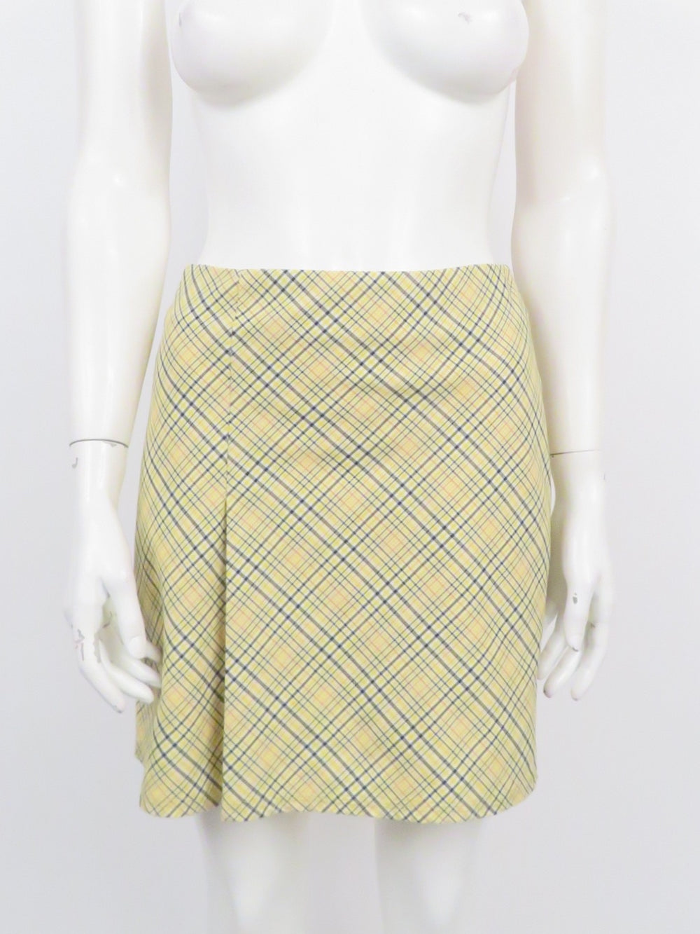 random pieces yellow plaid mini skirt. features diagonal plaid print. zipper at back middle. single pleat on left side front.