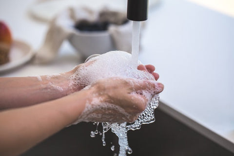 Washing hands clean with laundry soap