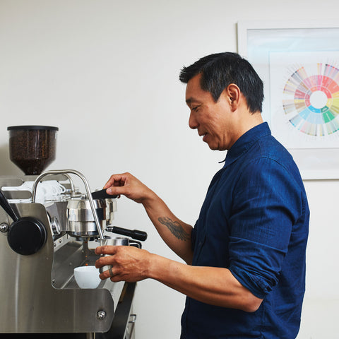 a person at an espresso machine