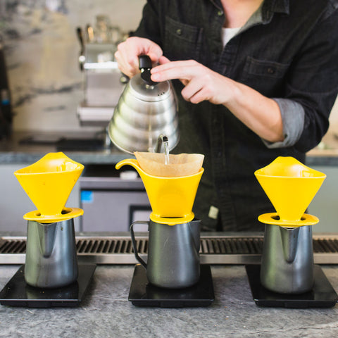 a person making pour over coffee