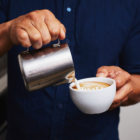 a person pouring latte art