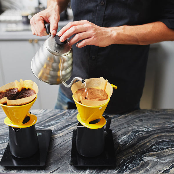 a man making a caffe luxxe pour over coffee