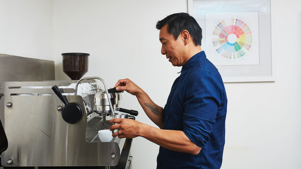 a person at an espresso machine