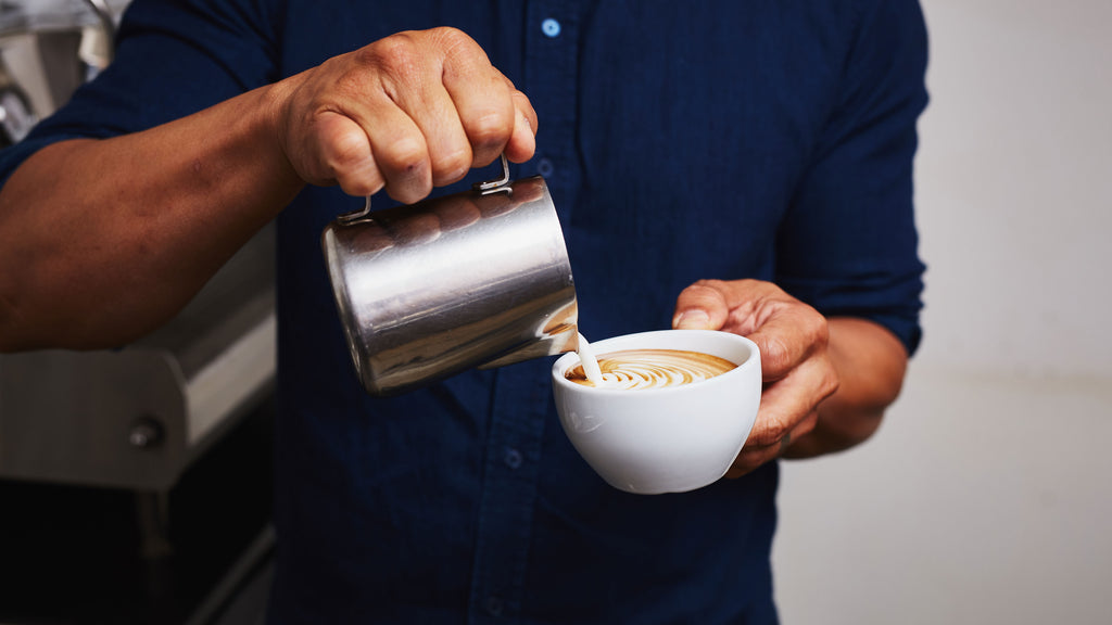 a person pouring latte art