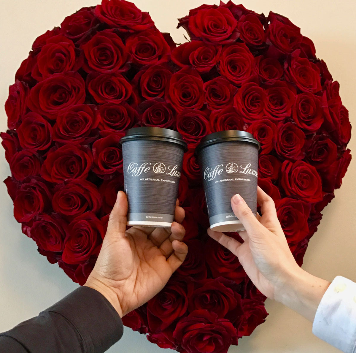 caffe luxxe coffee cups in front of heart rose bouquet