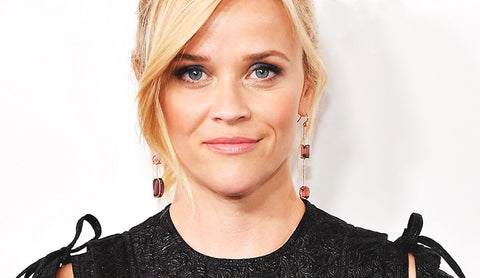 Reese Witherspoon, in cool gemstone earrings, representing a new age for women in Hollywood.