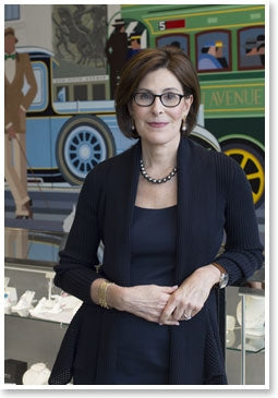 Esther Fortunoff in their New York store leaning against a display case full of quality jewelry