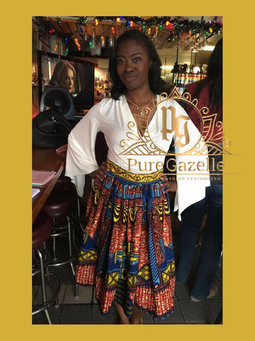 Happy Woman modeling Pure Gazelle custom African Print skirt in red and blue