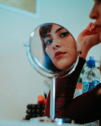 Woman looking into mirror