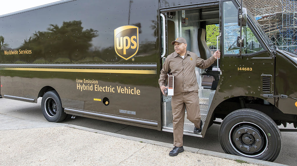 UPS driver with low emissions delivery truck