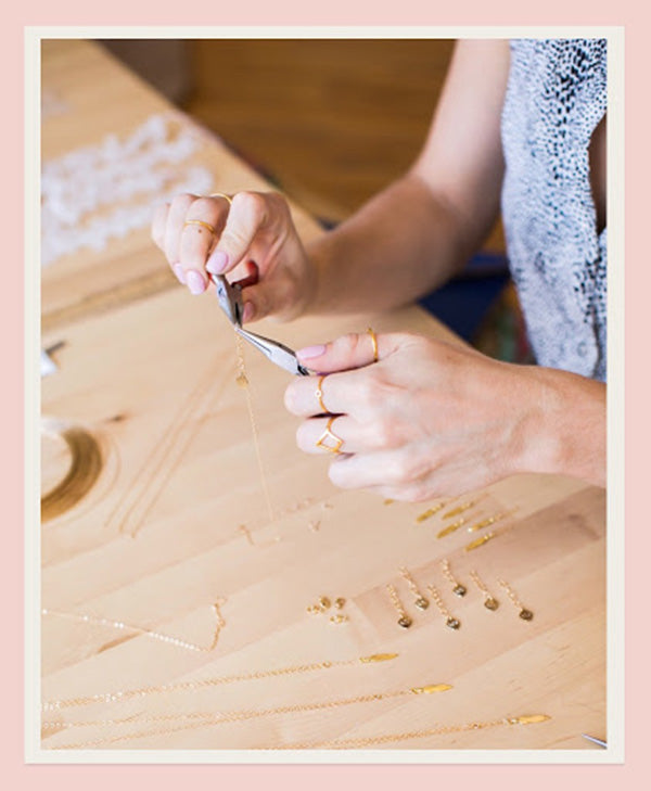 Katie Dean assembling jewels on a necklace.