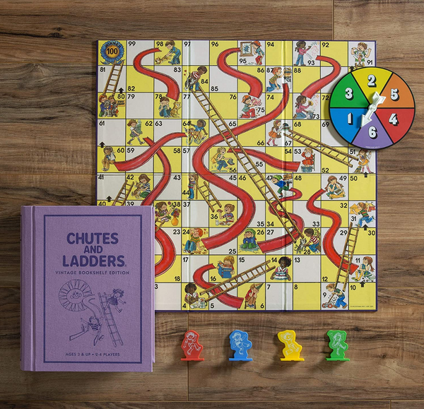 Chutes and Ladders Board Game as seen laid out on top of a wooden background