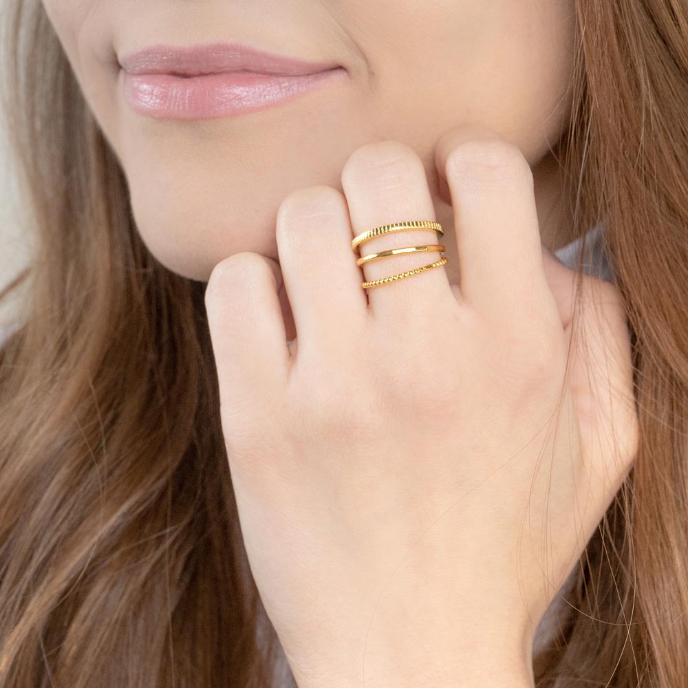 Woman's hand near face wearing Katie Dean Jewelry Minimal Stack Rings
