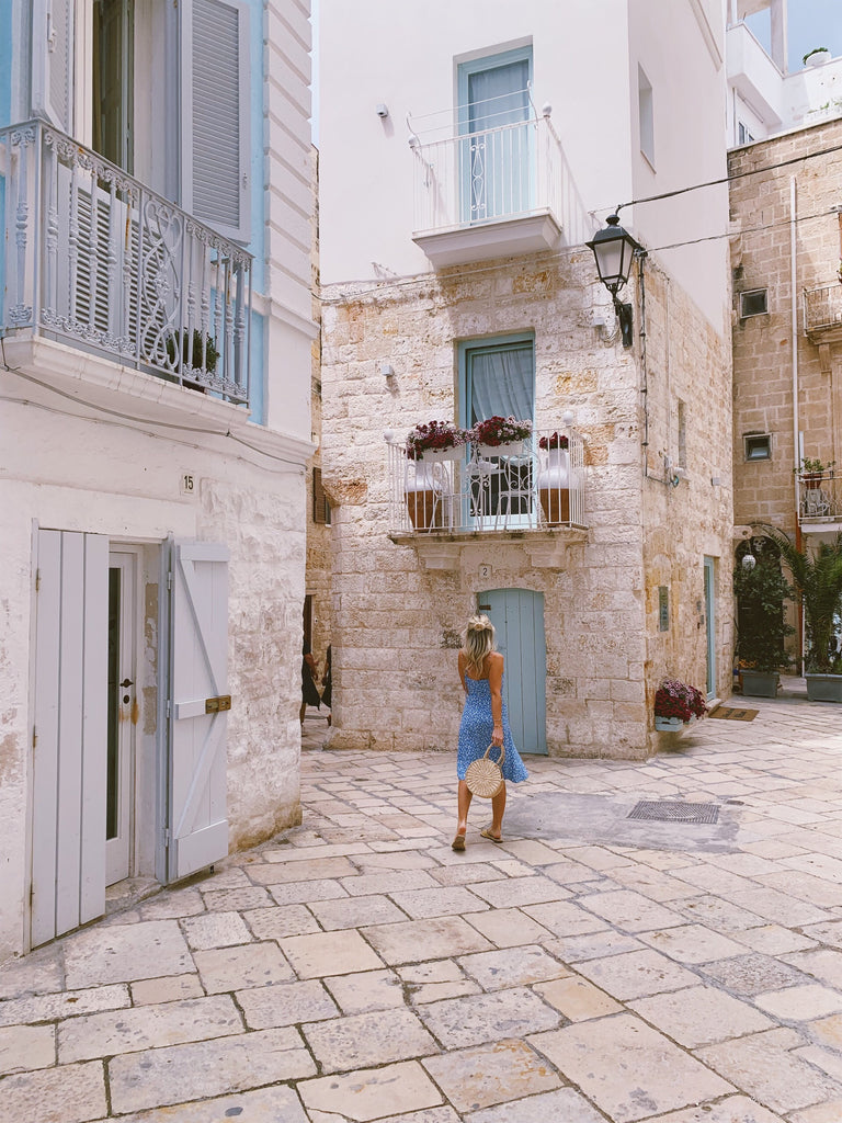 Polignano a Mare white town with Katie in Blue Dress