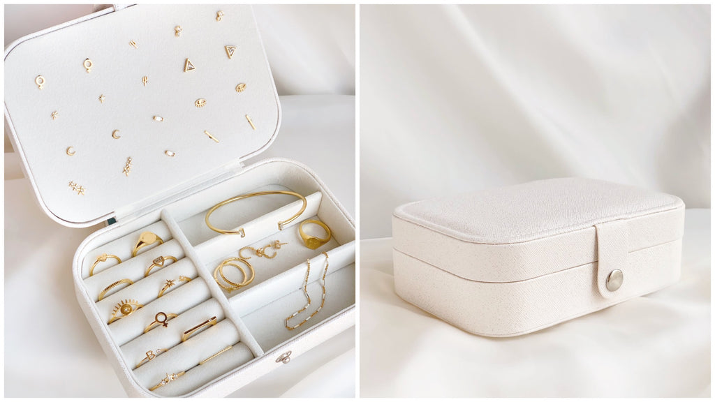 White jewelry case with dainty gold rings, earrings, bracelets inside handmade by Katie Dean Jewelry