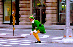 A .gif of Buddy the elf jumping across the street in a scene from the movie "Elf".