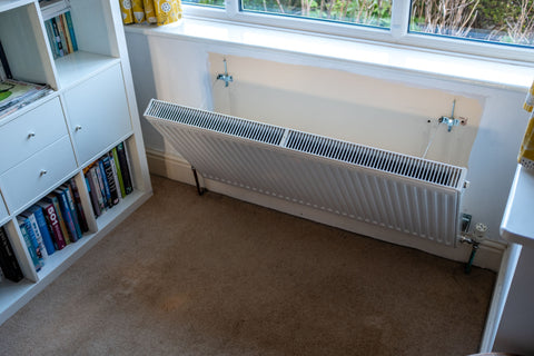 Removing a radiator from the wall for cleaning - allergies - case study - Rotarad