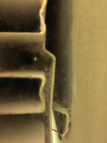 accumulated dust behind radiator