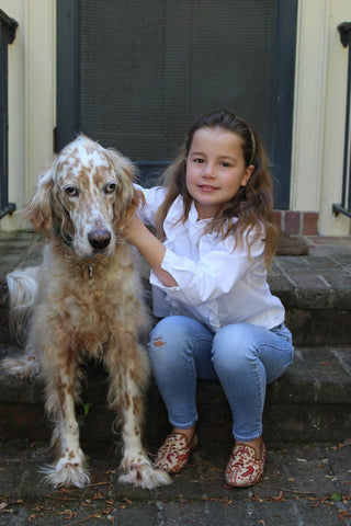 caroline with pet dog in sumak kilim loafers, part of childrens shoes collection.