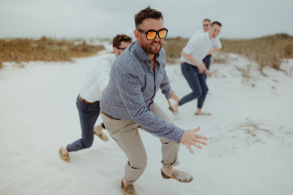 groom running on the beach in mens kilim loafers
