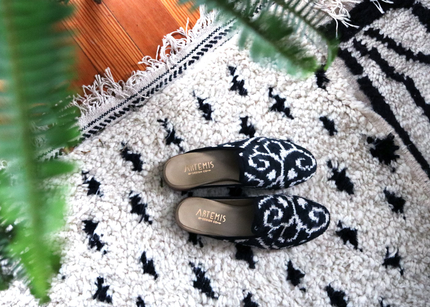 our black and white velvet slippers on a moroccan carpet in milicent's home. 