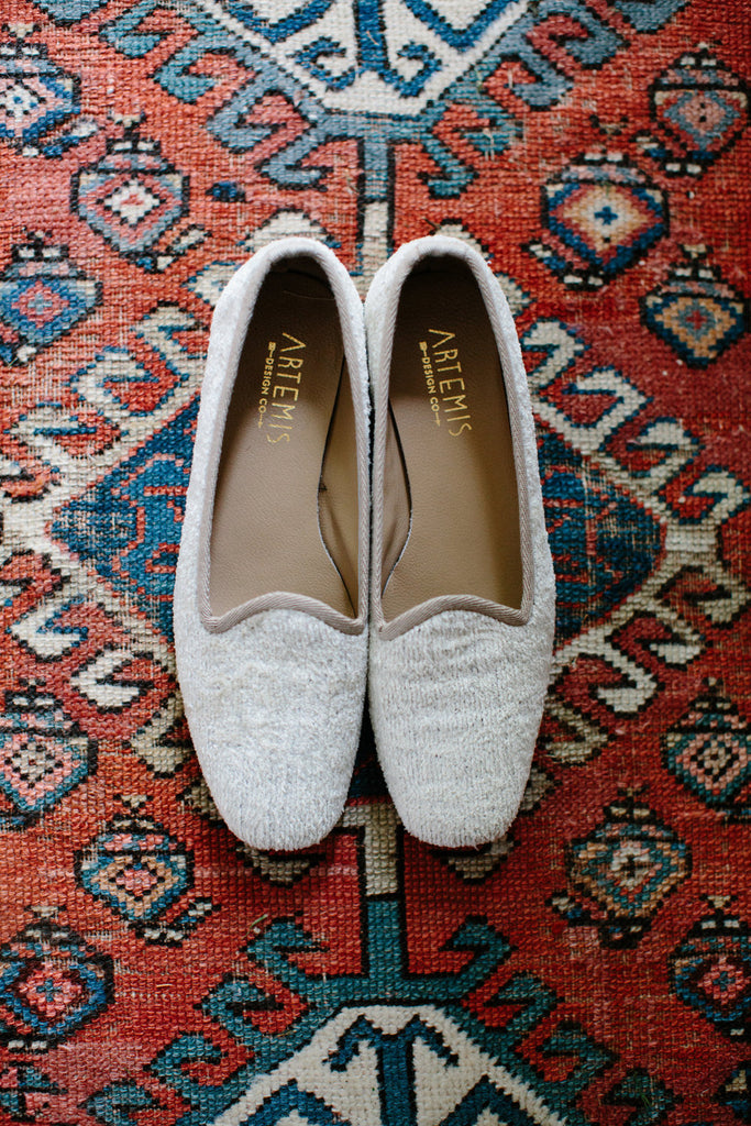 our pearl silk velvet loafers on a carpet.