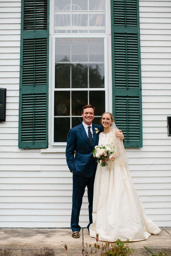 Portrait of the newly weds. Groom wearing mens kilim loafers, bride wearing pearl silk slippers.