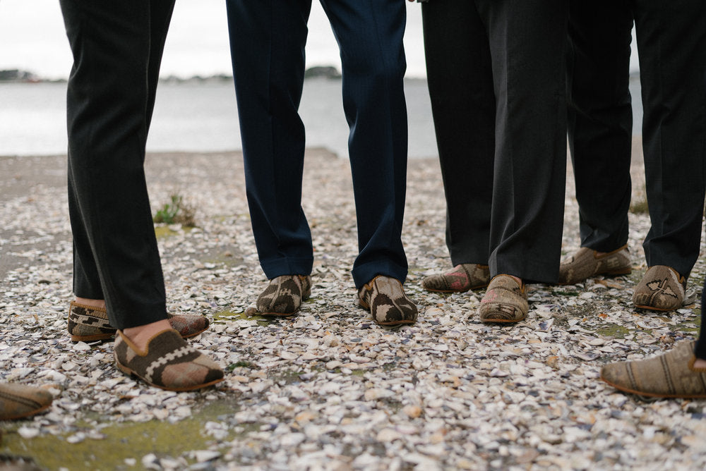 Groomsmen standing on the beach in their mens kilim loafers
