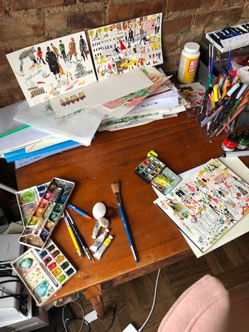 paulines brown desk with paint supplies and illustrations of womens kilim loafers.