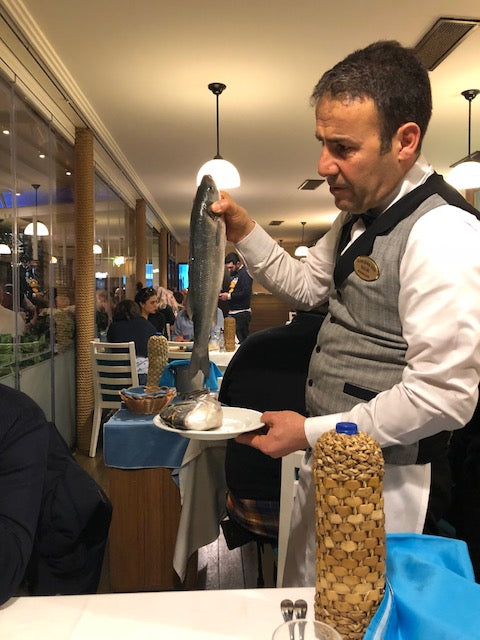 Waiter in Istanbul holding fish for dinner. 